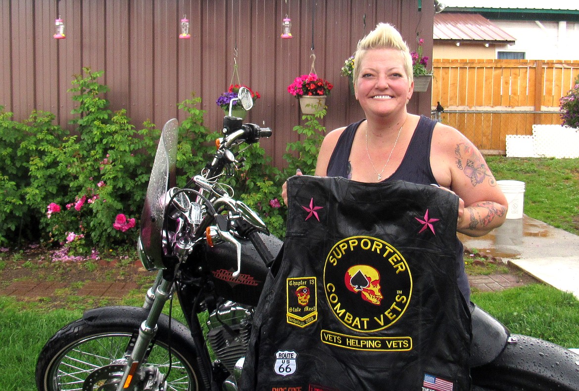 Chris Arnold shows off her Combat Veterans Motorcycle Association vest and 2016 Harley Sportster ‘72.
