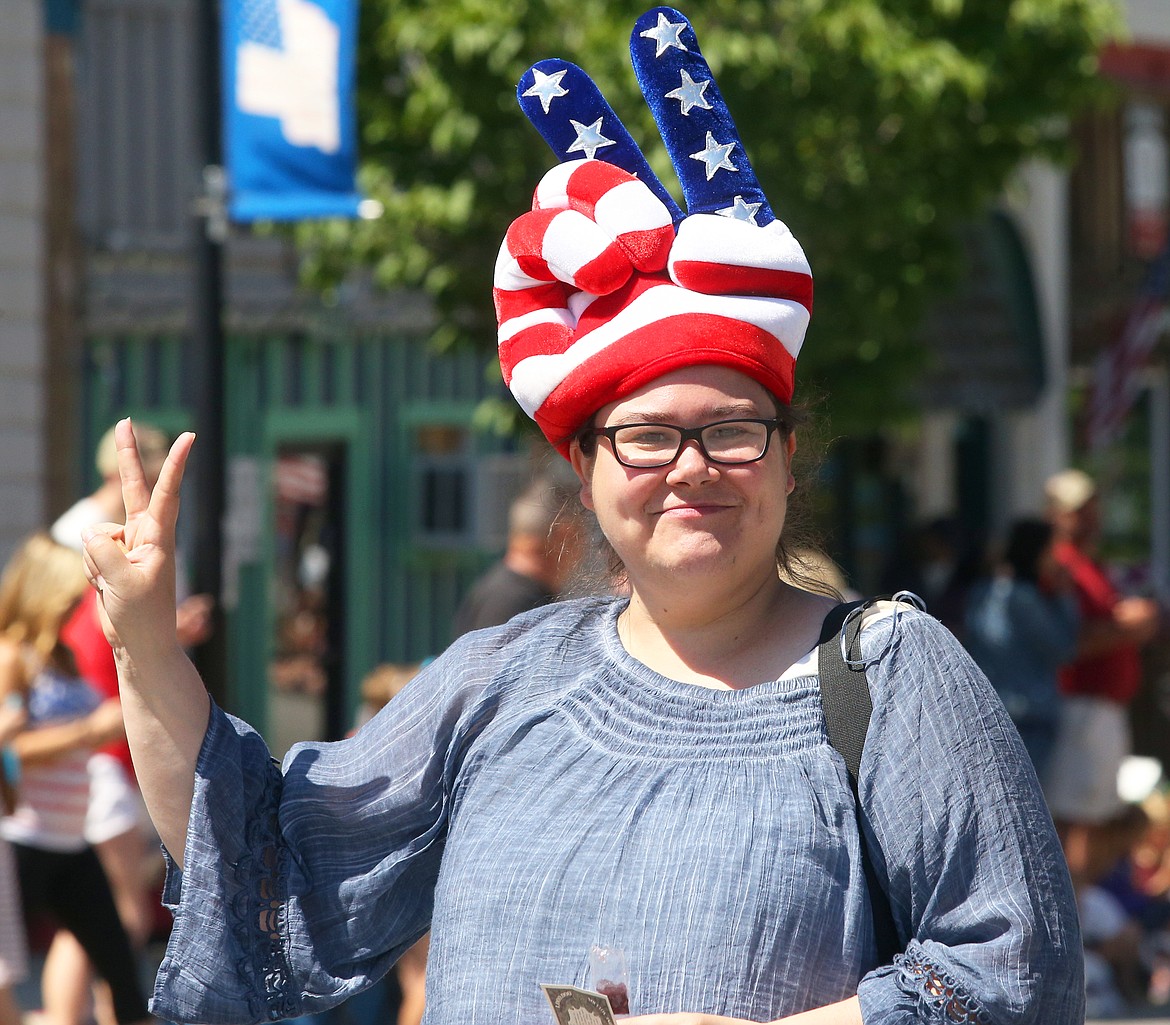 BILL BULEY/Press 
 Katrina Davis offers a peace sign after the Fourth of July parade at Spirit Lake on Saturday.