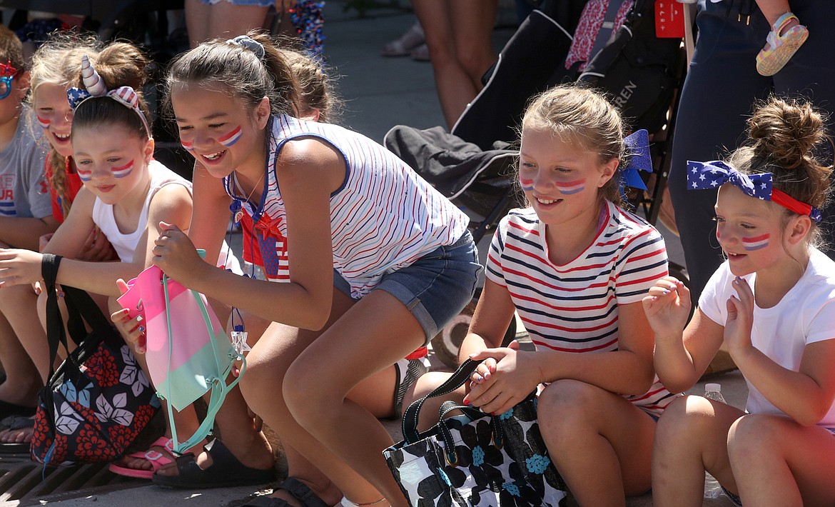 BILL BULEY/Press 
 Kids start to scramble for candy tossed to them during the Fourth of July parade in Spirit Lake on Saturday.