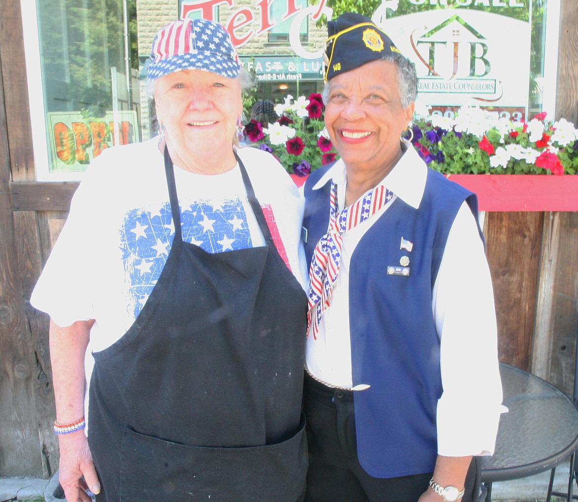 BILL BULEY/Press 
 Terry Shepherd, left, and Gloria Robinson watched the Spirit Lake parade from in front of Terry's Cafe on Saturday.