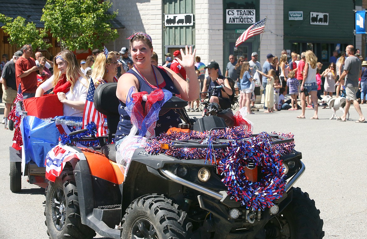 BILL BULEY/Press 
 Jeneva Stubbs of Spirit Lake Visions smiles and waves during the Fourth of July parade at Spirit Lake on Saturday.