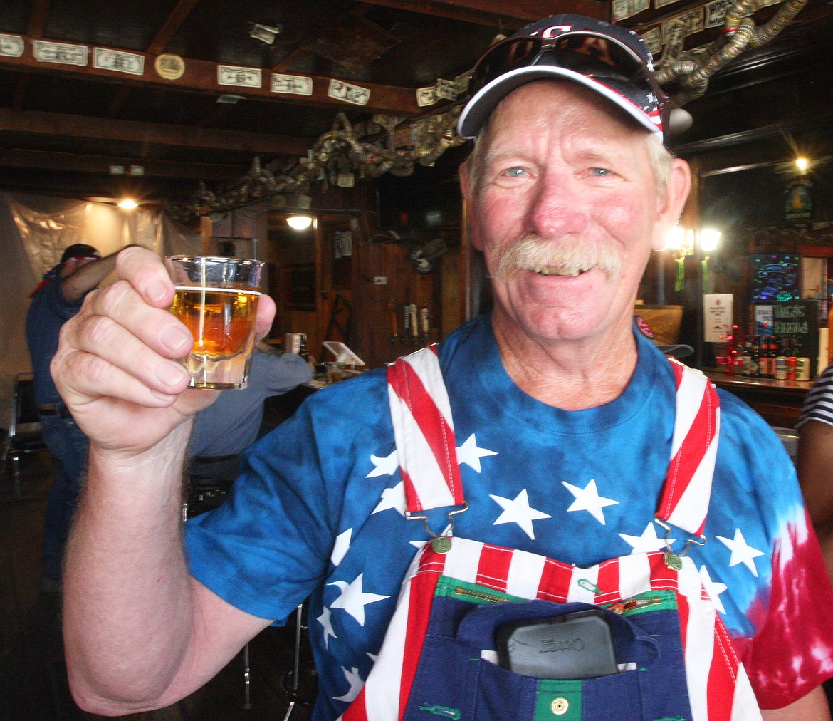 Bill Logue of Spirit Lake upholds his tradition with a shot at the White Horse Saloon after the Spirit Lake parade on Saturday.
