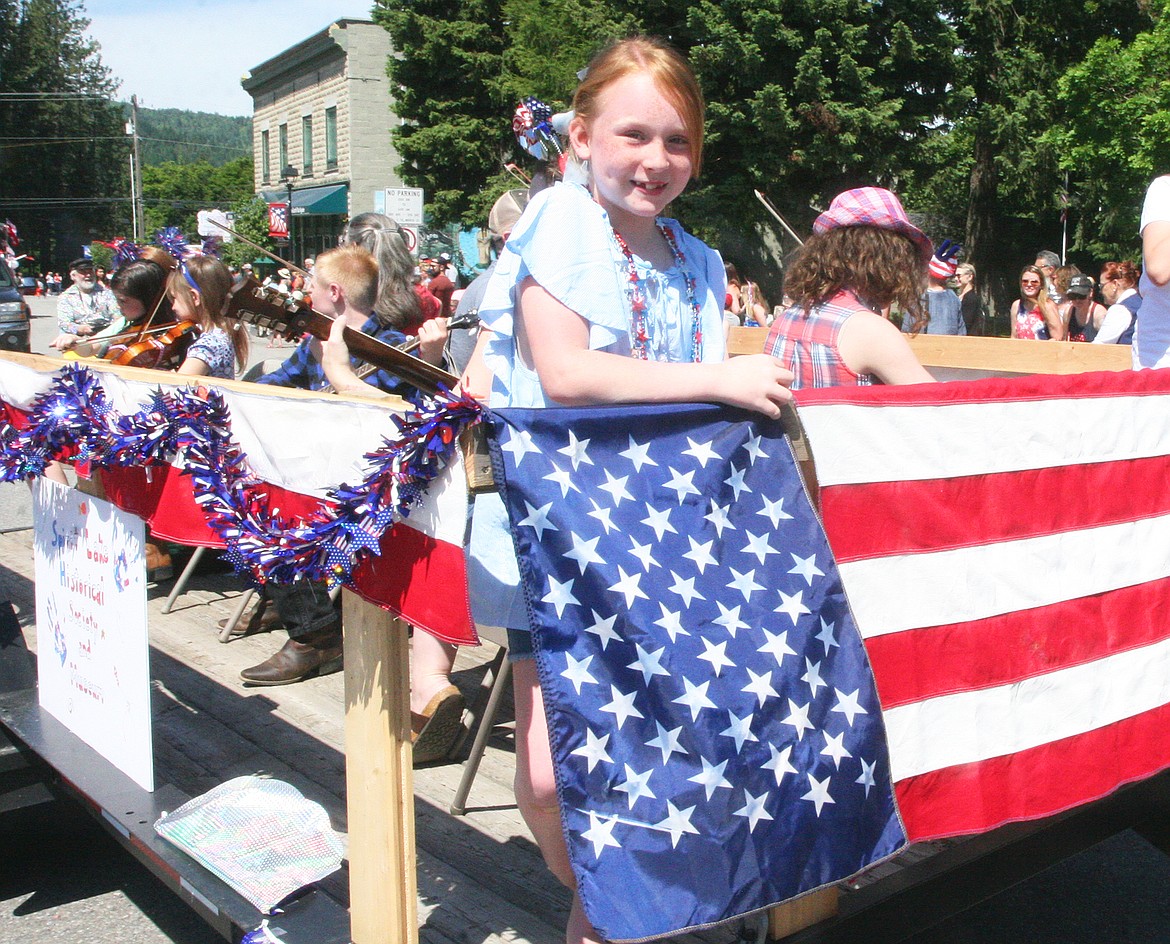 BILL BULEY/Press 
 Marlee Jerome enjoys being part of the Fourth of July parade at Spirit Lake on Saturday.