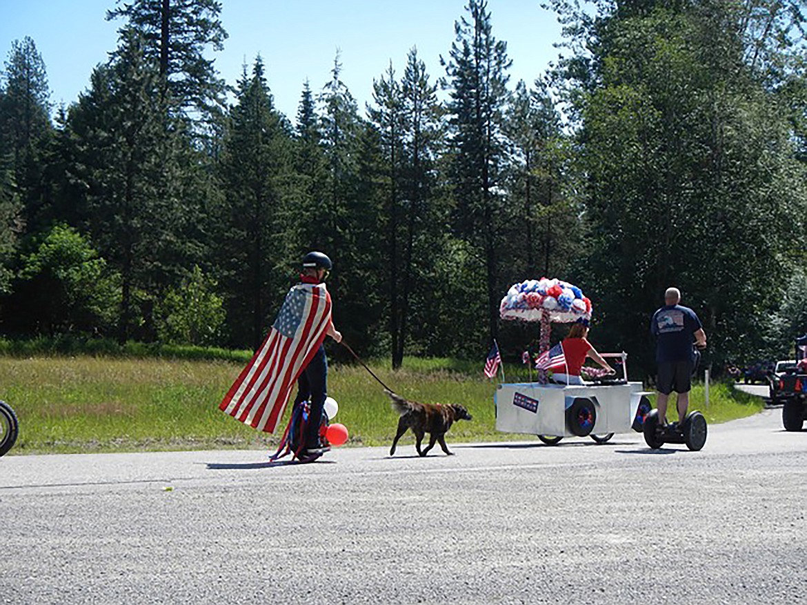 (Photo courtesy JERRY LUTHER) 
 Participants make their way down the parade route during the annual Fourth of July parade in the annual Fourth of July parade in the Garfield Bay area in Sagle.