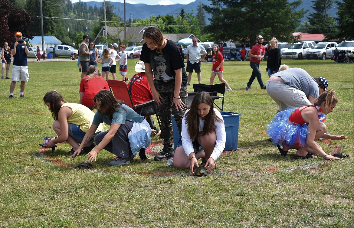 (Photo by DYLAN GREENE) 
 A group of teenagers prepare to release their turtles.