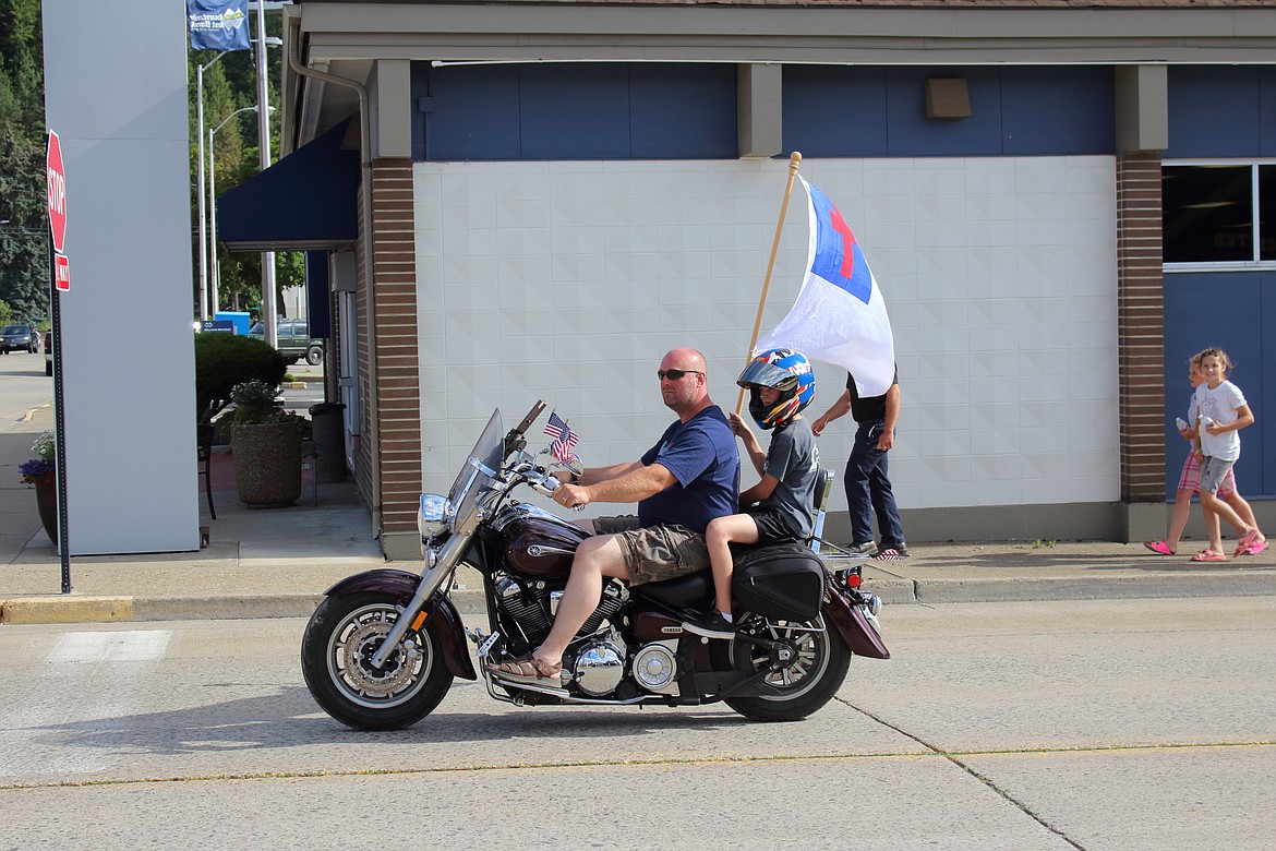 (Photo by VICTOR CORRAL MARTINEZ) 
 Bonners Ferry residents take part in a community parade on the Fourth of July.