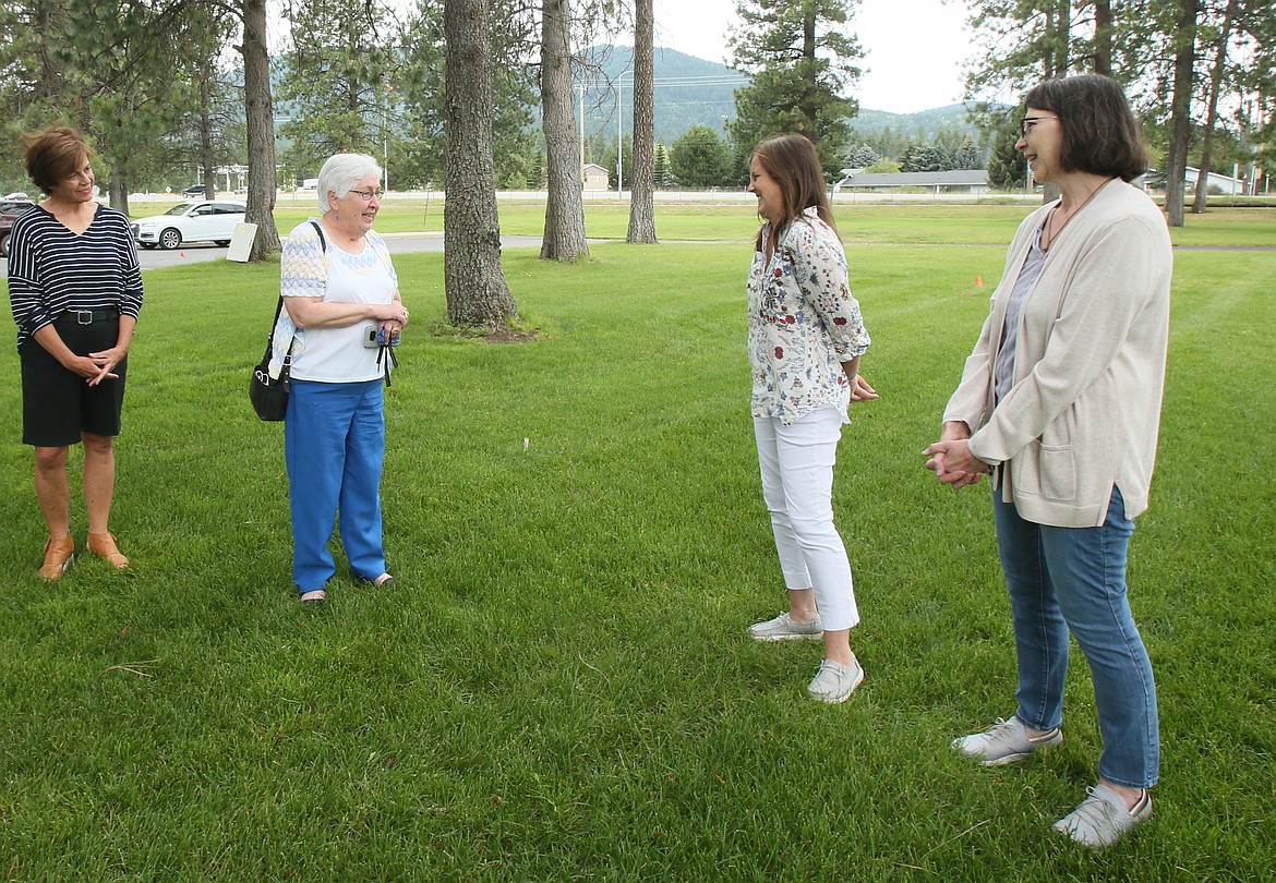 Women's Gift Alliance Vice President Jovanna Tanzey, left center, shares a sweet moment with Cup of Grace founder Amy Privitt, right center, as Tanzey discusses why WGA feels Cup of Grace is such a worthy cause. Also pictured: WGA member Debra Stoenner, far left; and Cup of Grace secretary Tamara Wheeler, far right. (DEVIN WEEKS/Press)