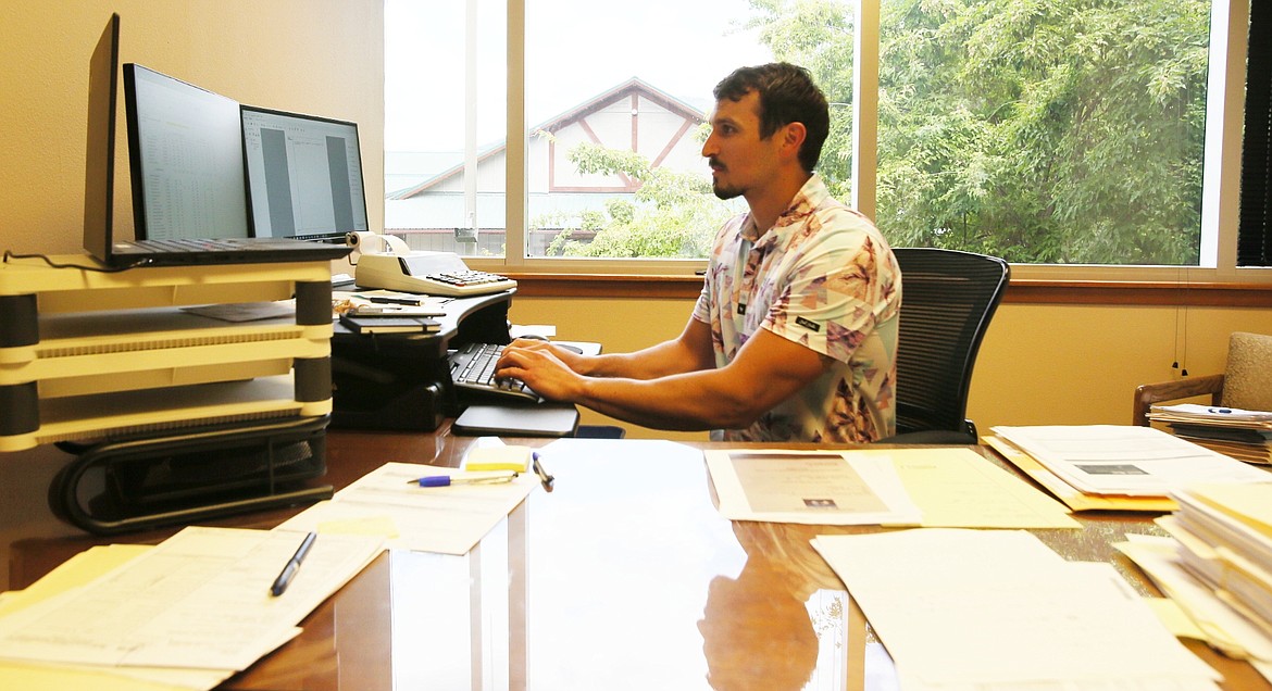 Harris CPAs tax manager Terry Kissler handles some end-of-the-week paperwork on Friday. Accountants everywhere are looking forward to the end of tax season, which comes to a close Wednesday on Tax Day. (DEVIN WEEKS/Press)