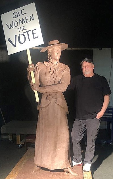 Artist Terry Lee poses with his latest sculpture, “The Suffragist.” (Courtesy photo)