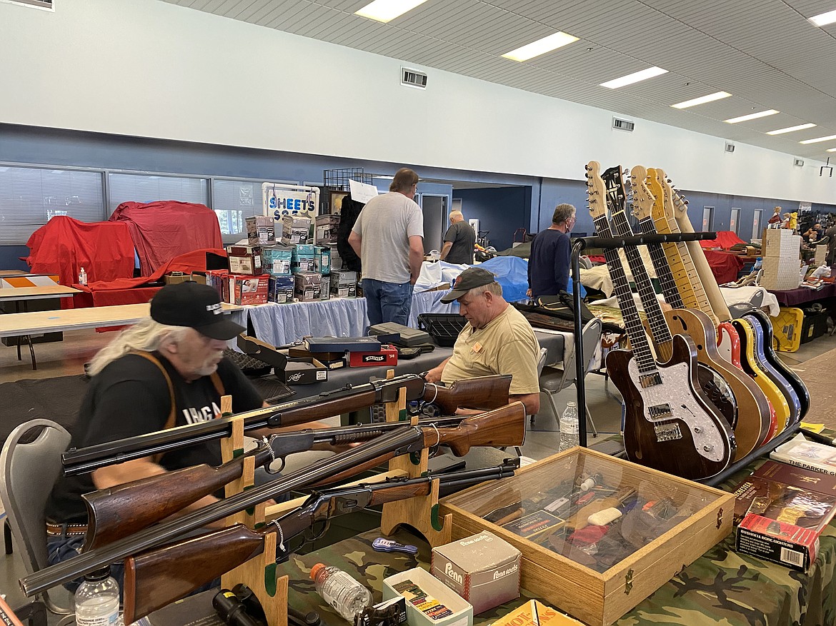 (MADISON HARDY/Press)
Live Wire sets up their display of custom guitars and firearms Friday.