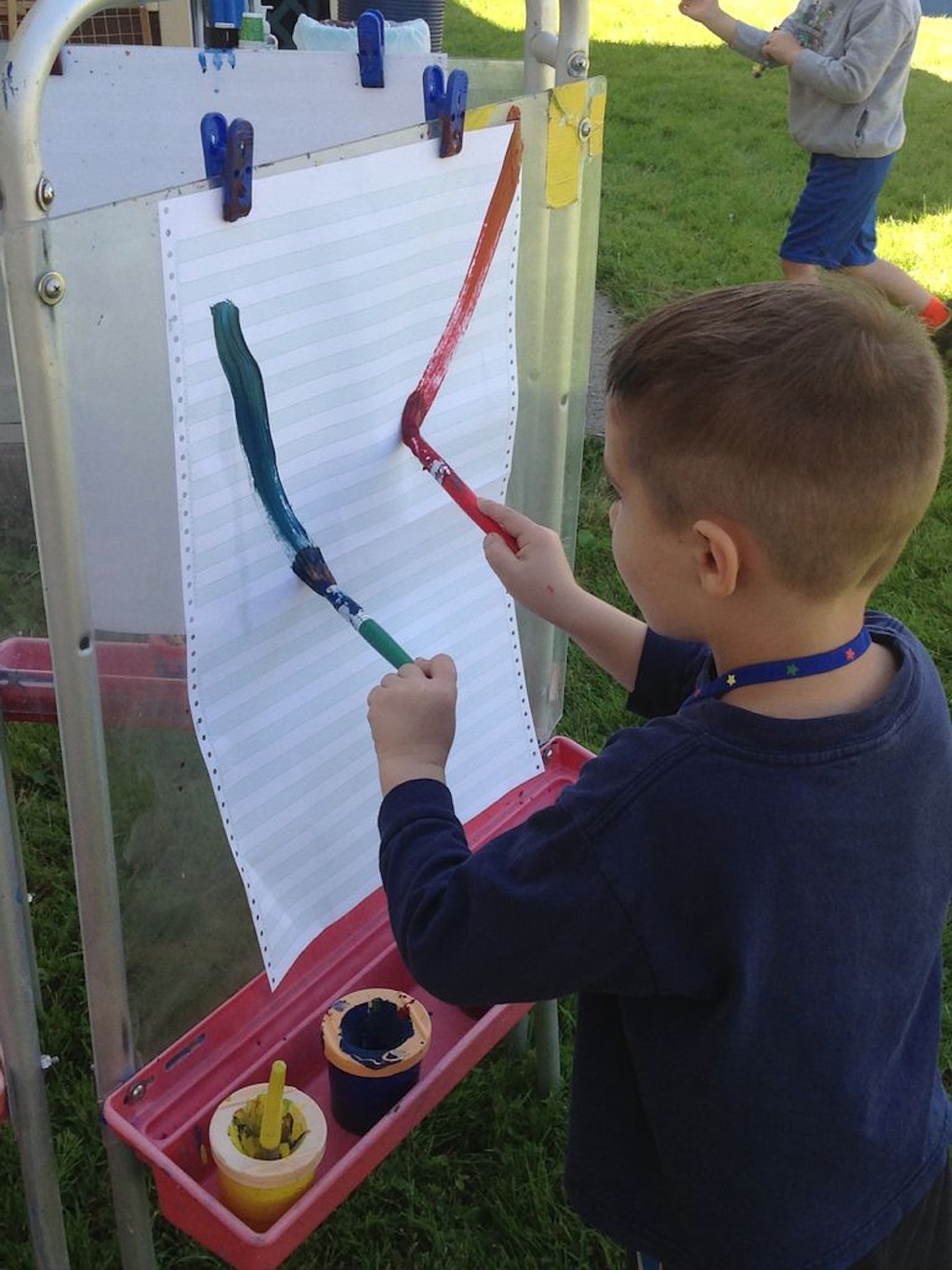 A youth concentrates while painting during a North Idaho College Head Start program recently.  Approximately 120 young children are returning to Head Start learning facilities in five northern counties this week as part of a four-week special summer session.