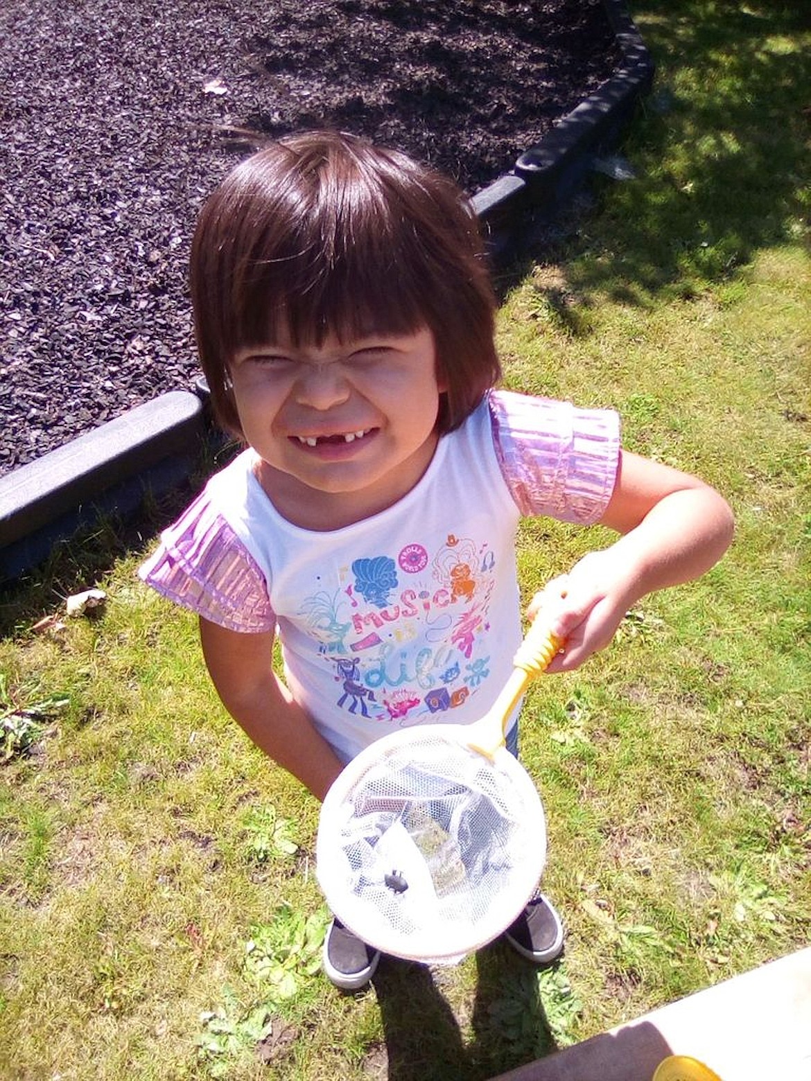 A young girl proudly shows off a bug she captured to study as part of a North Idaho College Head Start program recently.  Approximately 120 young children are returning to Head Start learning facilities in five northern counties this week as part of a four-week special summer session.