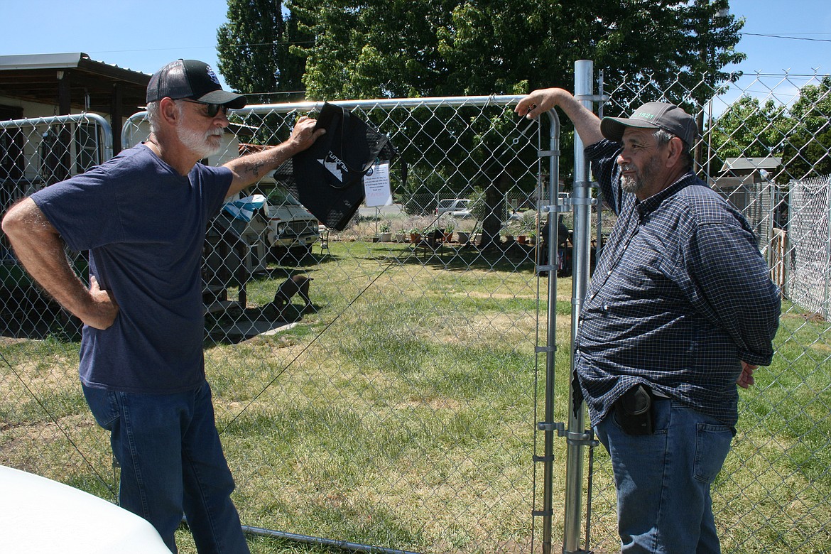 Steve Czimbal, left, a volunteer for the Meals to Heal program sponsored by the Columbia Basin Cancer Foundation, stops to talk with program recipient Jose Cavazos.