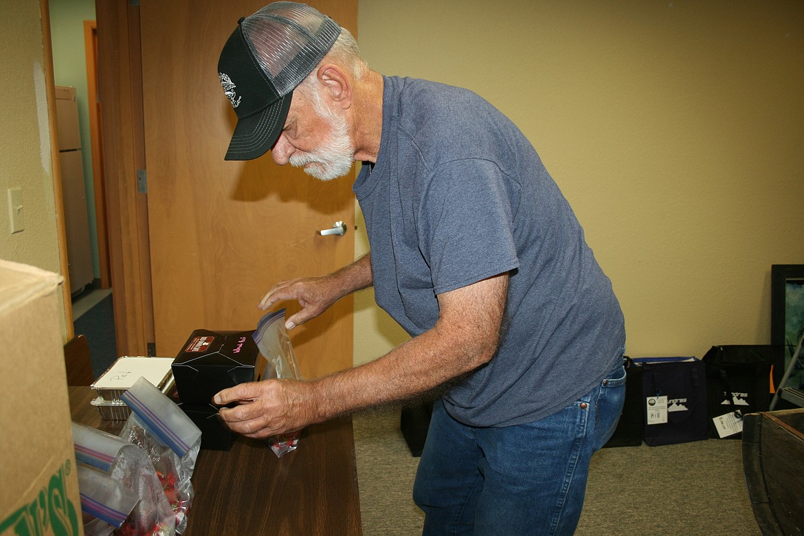 Steve Czimbal assembles the meal that will go to a client of the Meals to Heal program sponsored by the Columbia Basin Cancer Foundation.