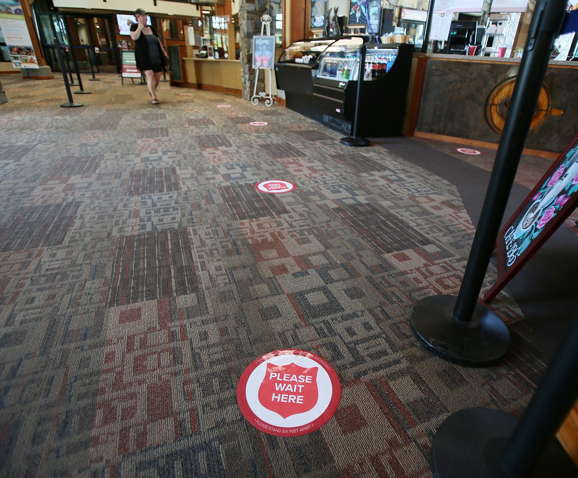 Floor indicators in the Kroc Center let people know to stay at least six feet from others as they wait in line. (DEVIN WEEKS/Press)