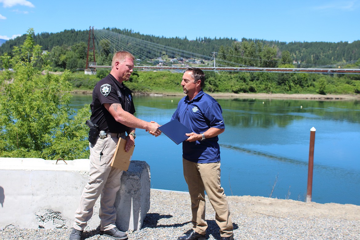 Boundary County Deputy Caleb Watts, left, is honored as the Idaho Marine Deputy of the Year by David Dahms, boating program manager with the state’s Department of Parks and Recreation.