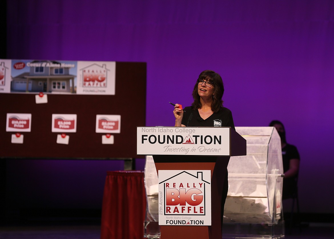 North Idaho College Foundation executive director Rayelle Anderson holds up a winning raffle ticket while she addresses the camera during the 27th annual Really BIG Raffle on campus Wednesday night. The event was closed to the public because of COVID concerns, but streamed live online. (DEVIN WEEKS/Press)