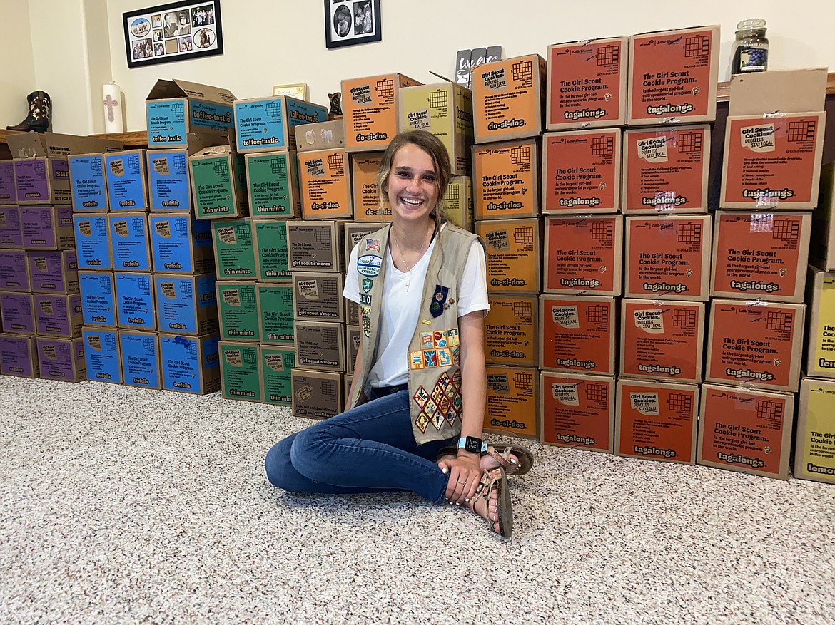 MADISON HARDY/Press 
 A proud Mikayla Butler sits with a few hundred of the cookies she'll donate to Camp Journey on Friday.