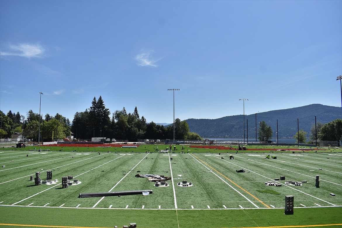 (Photo by DYLAN GREENE) 
 The artificial turf at War Memorial Field has been put down and workers are putting the finishing touches on the new surface as the start of the football season nears.