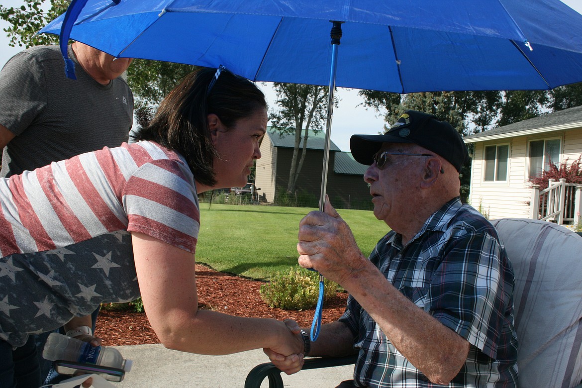 World War II veteran Geb Galle (right) got a parade of fire trucks and law enforcement vehicles Sunday in honor of his 99th birthday. Family friend Megan Cox (left) organized the drive-by.