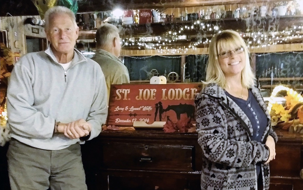 Larry and Lynnel Wolfe bought the St. Joe Lodge about 10 years ago and have lovingly restored it. It is now on the market for $550,000 as they plan to focus their energies on their life in another part of Idaho. They're seen here at the bar in the lodge, which was built in 1948. (Courtesy photo)