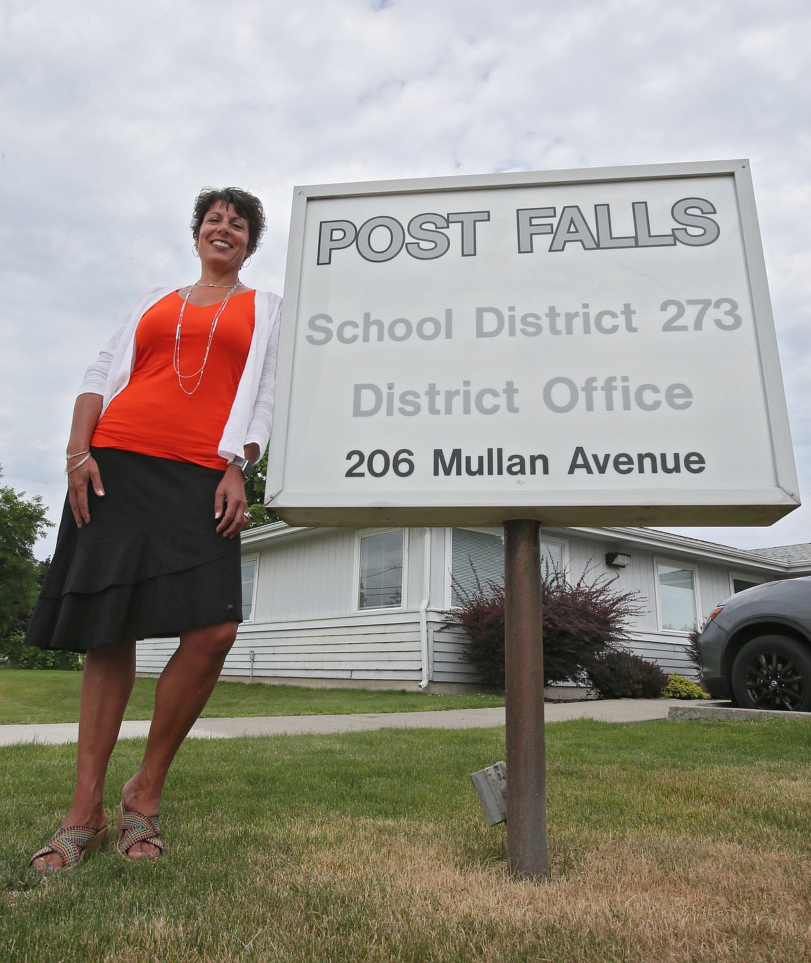 Post Falls School District Superintendent Dena Naccarato took the reins of the River City’s schools on Aug. 1. She’s seen here sporting Post Falls High School colors, black and orange, outside the district office on July 23.