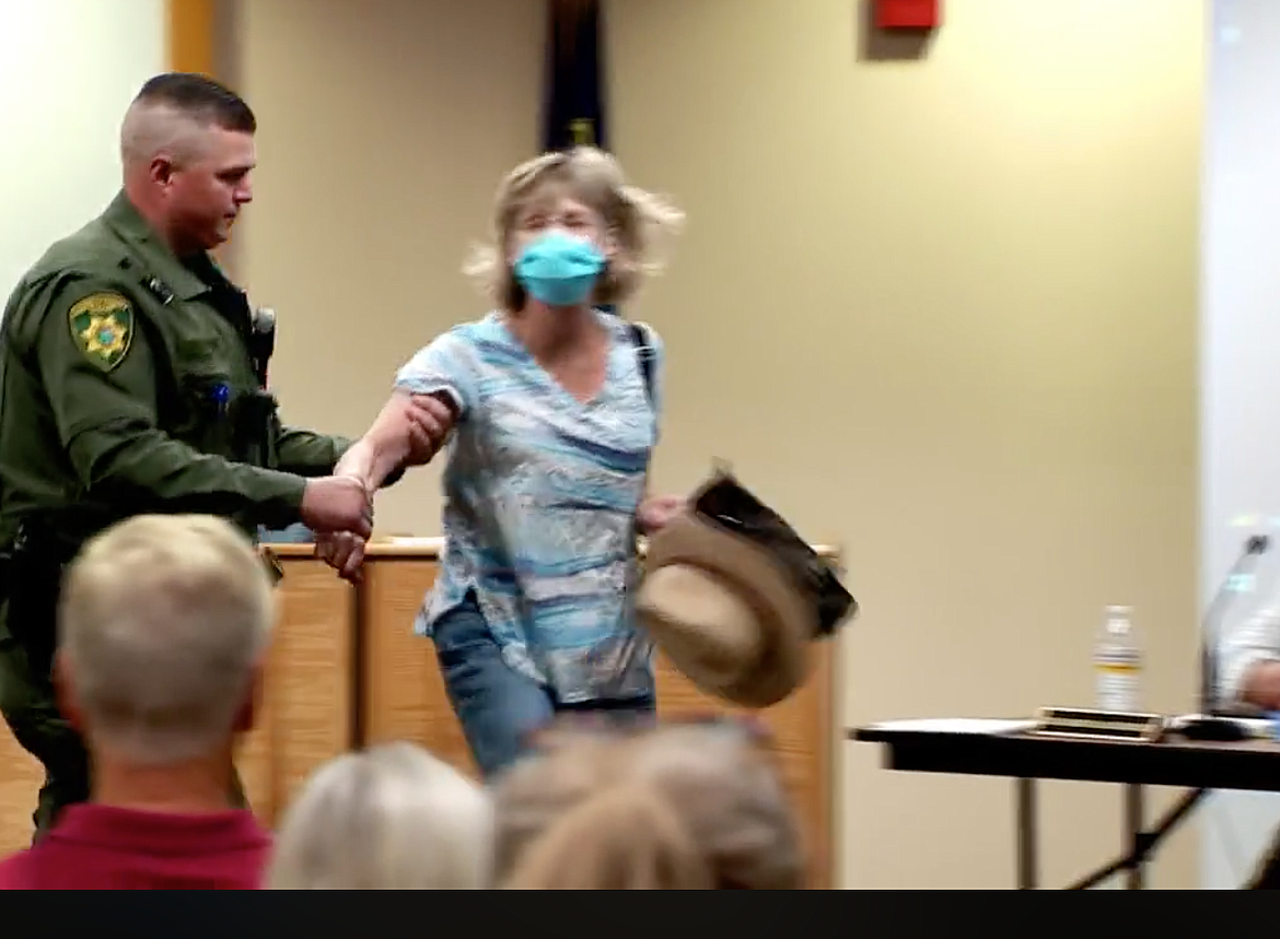 Tensions ran high throughout the more-than-three-hour Panhandle Health board meeting Thursday. A woman who was not able to speak during the public comment portion of the agenda was escorted out by the Kootenai County Sheriff’s Office after trying to be heard by the board. (Image courtesy of KHQ)
