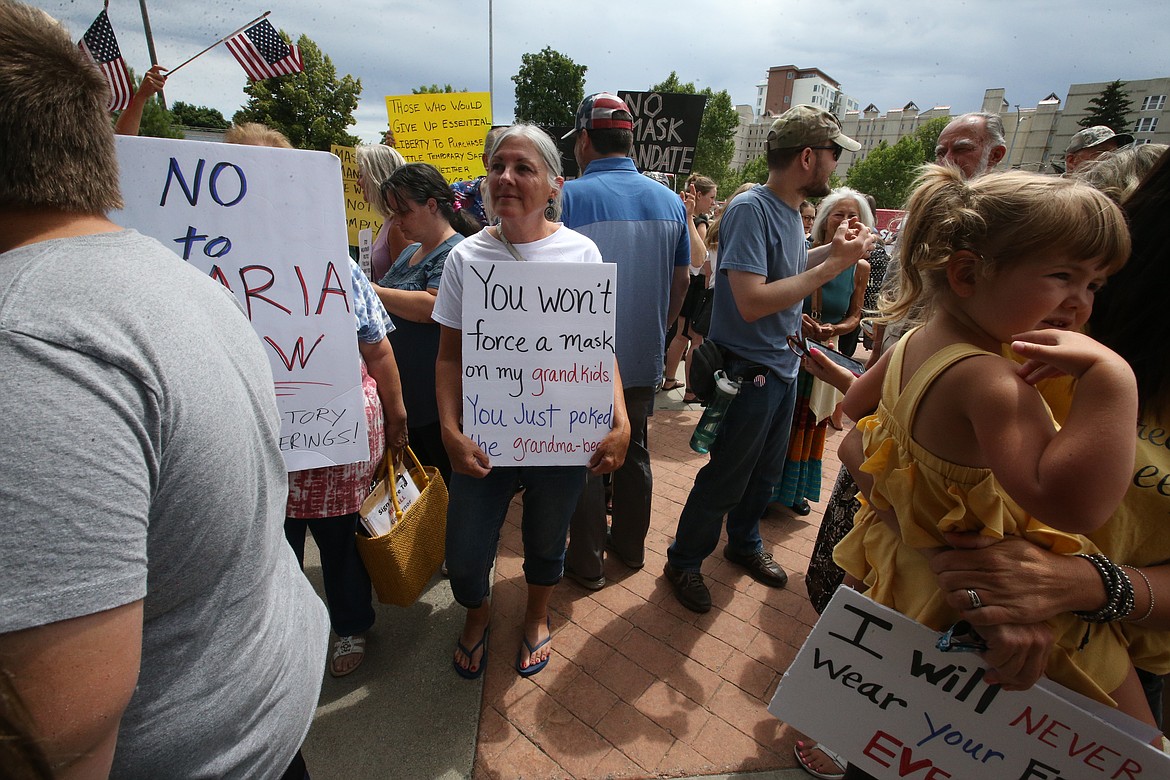 Bill Buley/Press 
 Linda Clark of Rathdrum stands in the middle of the crowd Thursday outside the PHD board meeting.