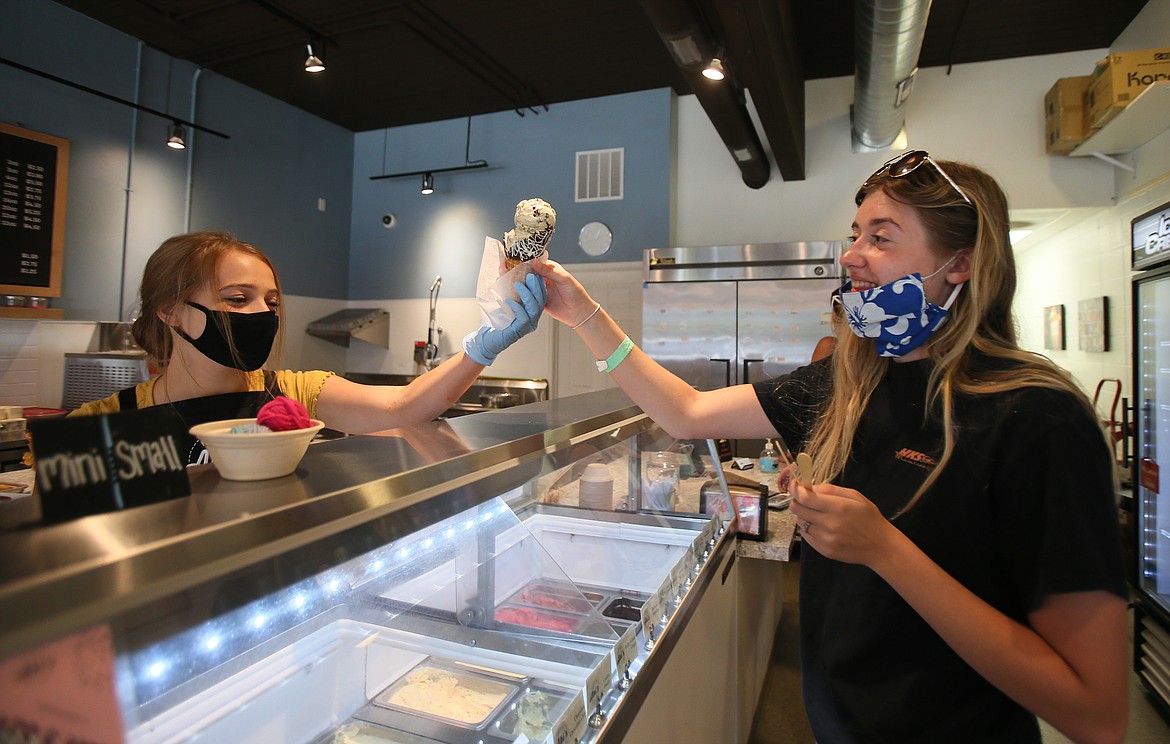 Abi's Ice Cream employee Ella Wilson serves Kimberly Reed, 17, a chilly treat Monday afternoon. "We have been so busy," employee Maclaryn Kelly said between customers. North Idaho is at the start of a heat wave, with a heat advisory in effect until Thursday night. (DEVIN WEEKS/Press)