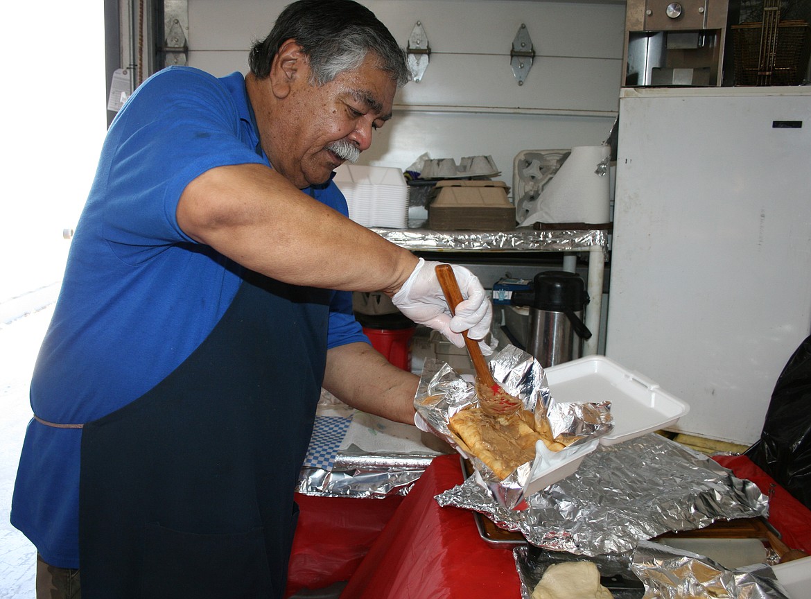 Top Gun concessions owner Jim Duzon adds topping to a maple bar. With many of its usual customers closed in 2020, Duzon and his wife Joy are finding other ways to get their name and menu out there.