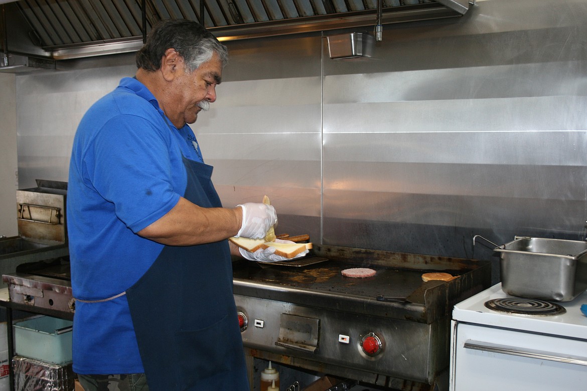 Top Gun owner Jim Duzon butters bread for a sandwich. With many of their regular customers closed for 2020, Duzon and his wife Joy are looking at other ways to promote their business.