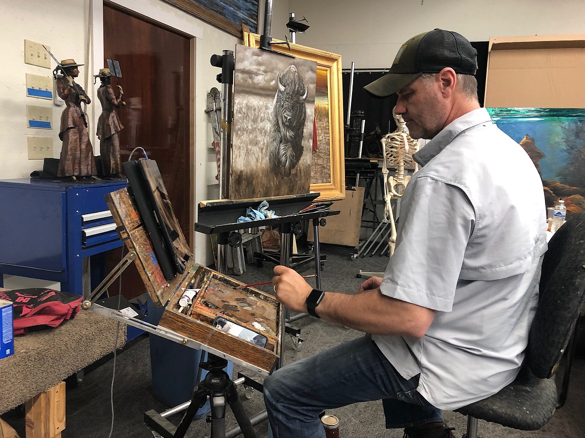 Local artist Joe Kronenberg demonstrates a traditional painting technique during a workshop he taught in Hayden July. The realist painter is known for his western wildlife oil paintings.