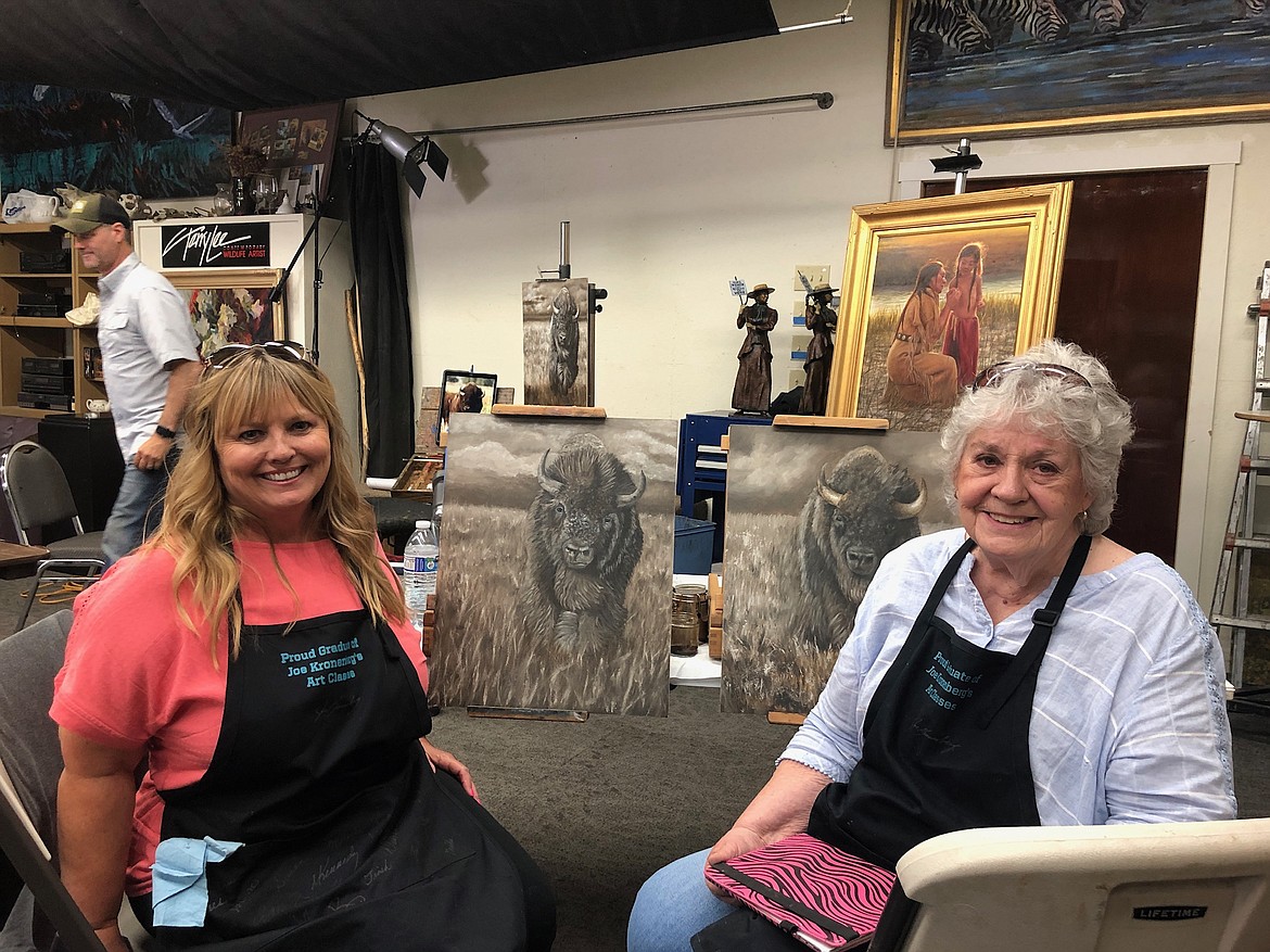 Michele Kennedy (L) and Delores Hickey pose with their paintings in progress. Both are experienced artists and are regulars of Kronenberg’s classes.