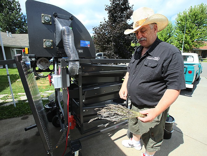 Ricardo Besel prepares to conduct a demonstration of the Besel Lavender Processor in his Coeur d’Alene driveway.