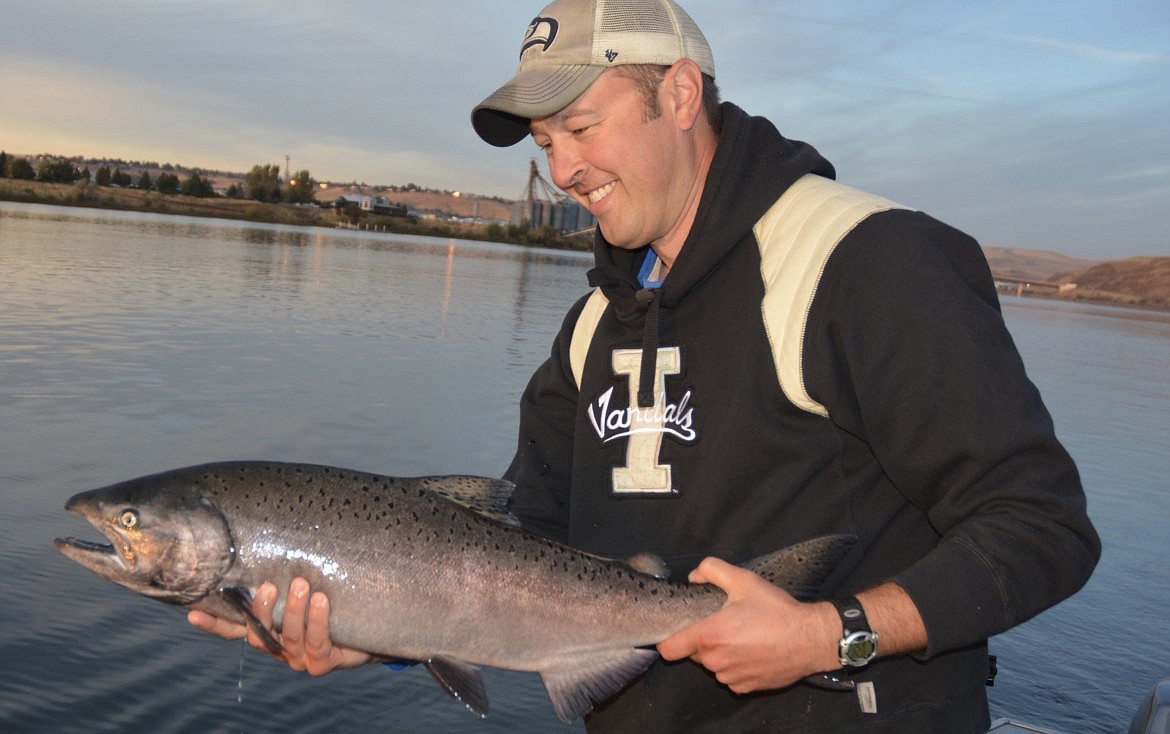 A Clearwater River angler hoists a Chinook salmon from the water upstream of Lewiston in this Idaho Department of Fish and Game photo.