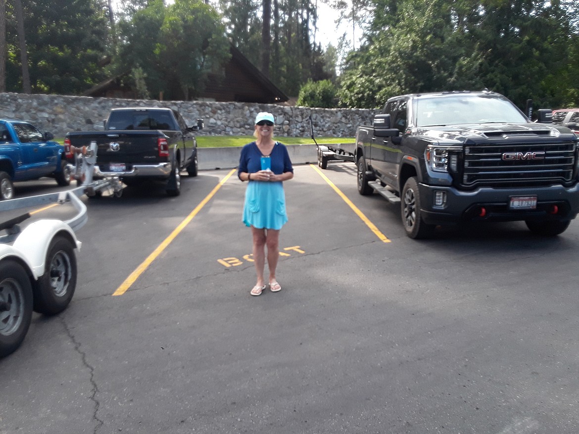 Local Germaine Carroll cheerfully guards a valuable Honeysuckle Beach parking spot as she waits for her husband to bring back their trailer from the boat launch. Parking in the popular Hayden lot has long been a commodity for beachgoers and boaters. A comment from the Hayden city council Tuesday night has the city re-evaluating potential solutions to the logjam. (CRAIG NORTHRUP/Press)