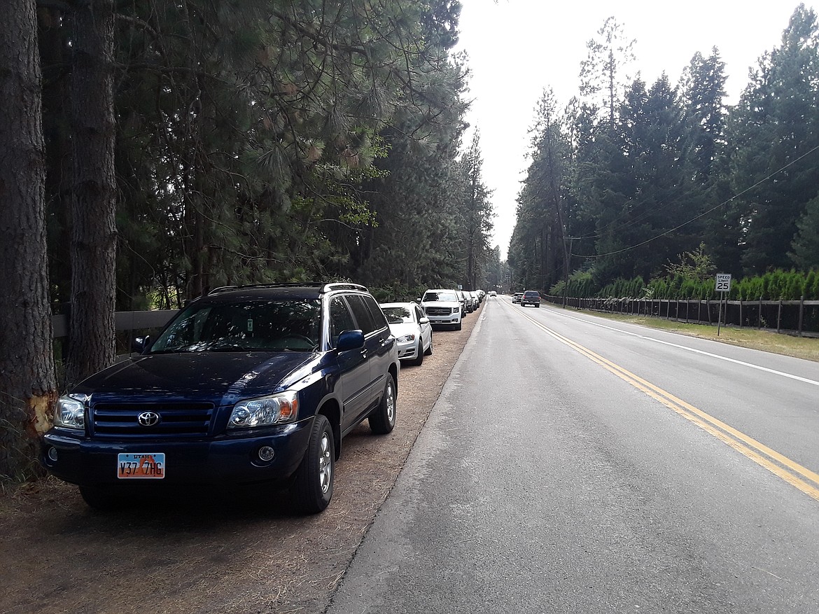 A third-of-a-mile string of cars stretched west along Honeysuckle Avenue Wednesday afternoon, including this SUV from Utah. Out-of-state visitors are enjoying Honeysuckle Beach, but the popular waterfront public access point is often congested over the summer, drawing concern from some of Hayden’s city officials. (CRAIG NORTHRUP/Press)