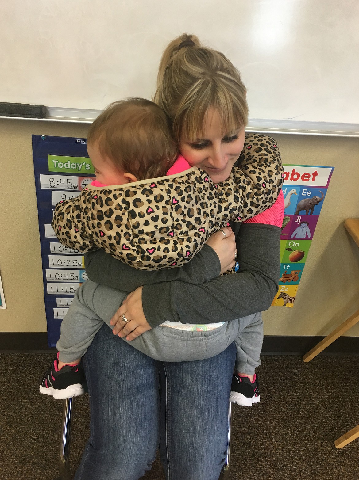 Syringa Family Partnership therapist Kaecie Rowe snuggles Macy Minert before working with big brother Ryan in 2015. "I loved how we would all come in and she would love on Macy before she started working with Ryan," mom Cassidy Minert said. Syringa serves children with disabilities, and their families are grateful for the dedication of its employees, especially during the pandemic lockdown. (Courtesy photo)