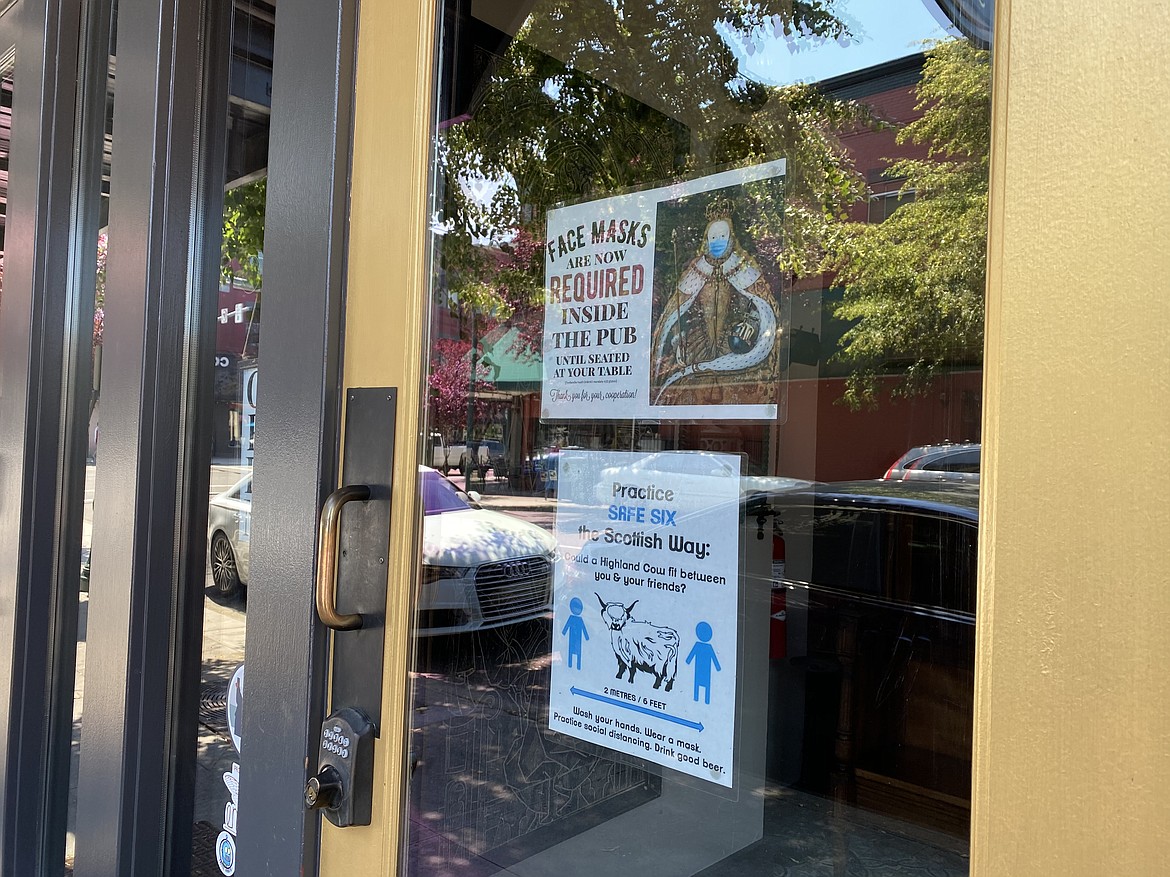 The Crown and Thistle Pub awares patrons of their mask mandate with signs outside the door. (MADISON HARDY/Press)