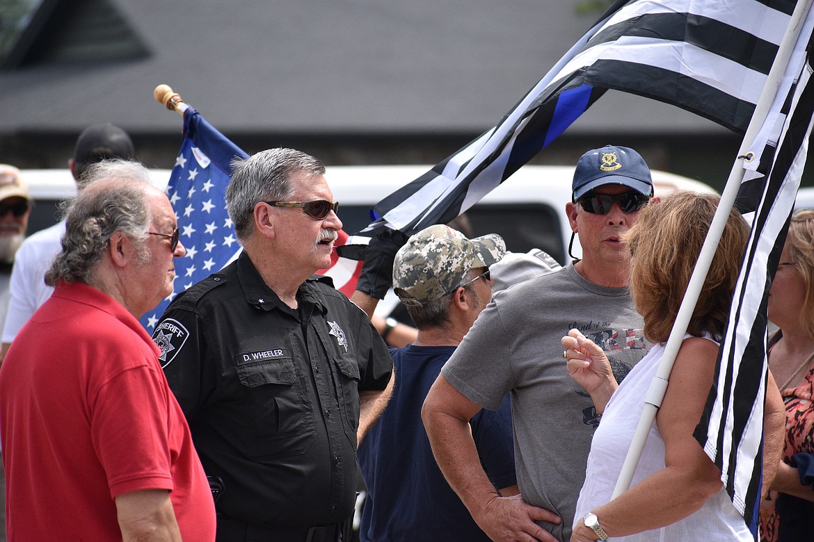 (Photo by DYLAN GREENE)
Bonner County Sheriff Daryl Wheeler (second to left) talks with residents during Saturday’s event.