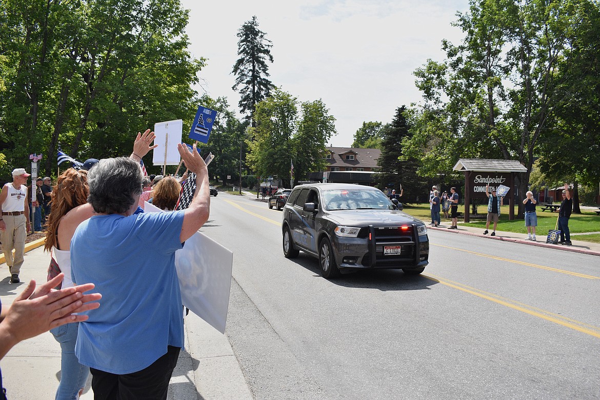 (Photo by DYLAN GREENE)
People cheer as a Ponderay Police Department officer drives by during Saturday’s event.