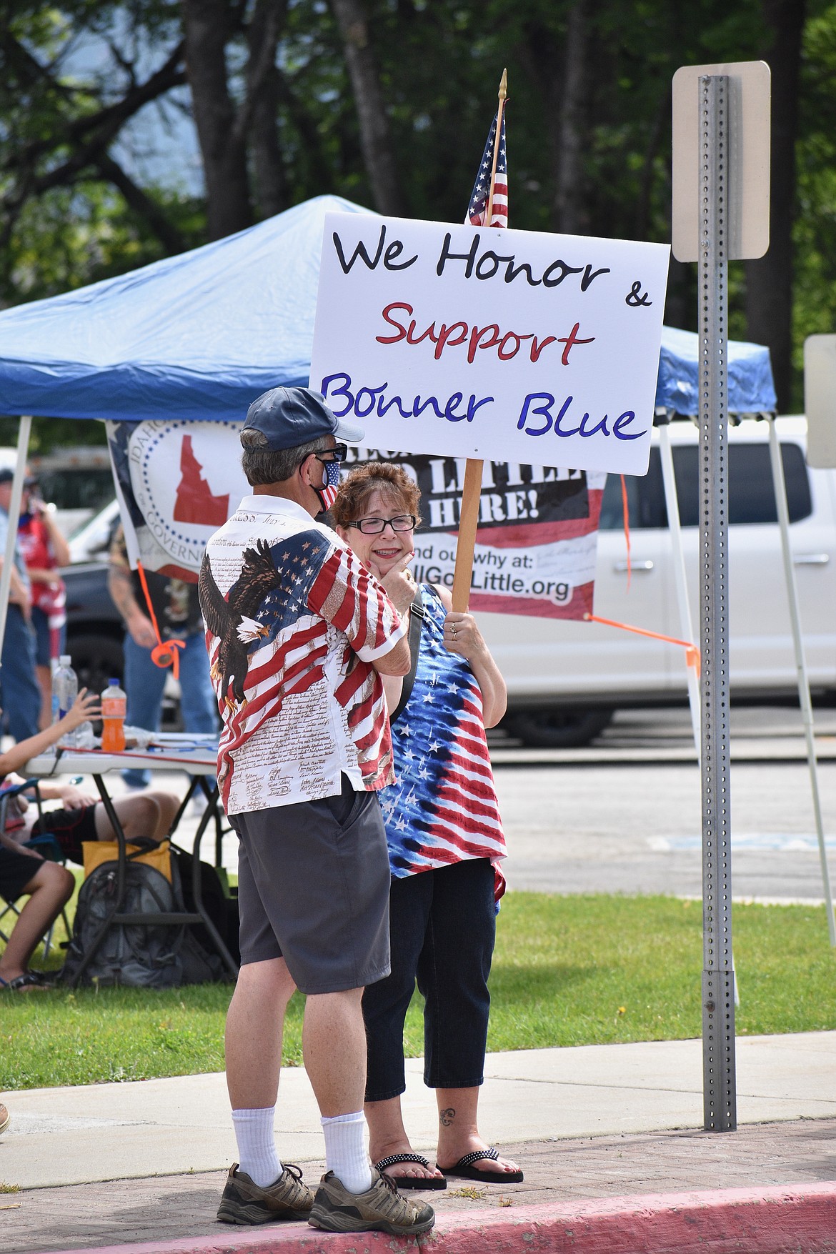 Kandy Brumley (right) holds up a sign showing support for local law enforcement during Saturday’s Back the Bonner Blue event.