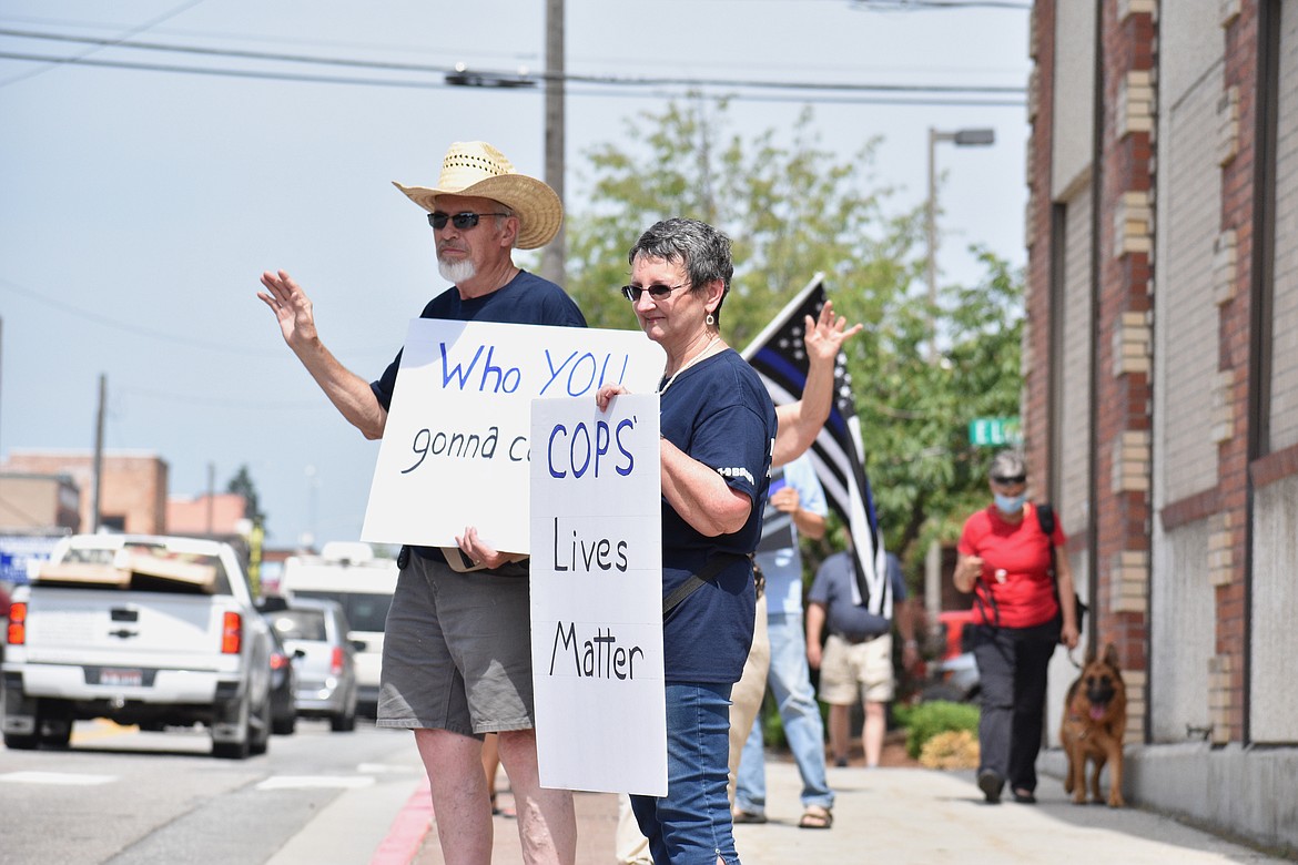 (Photo by DYLAN GREENE)
Rob Lowery (left) and his wife, Mavis, hold up signs supporting law enforcement during Saturday’s event. Rob’s sign said “Who You Gonna Call?”