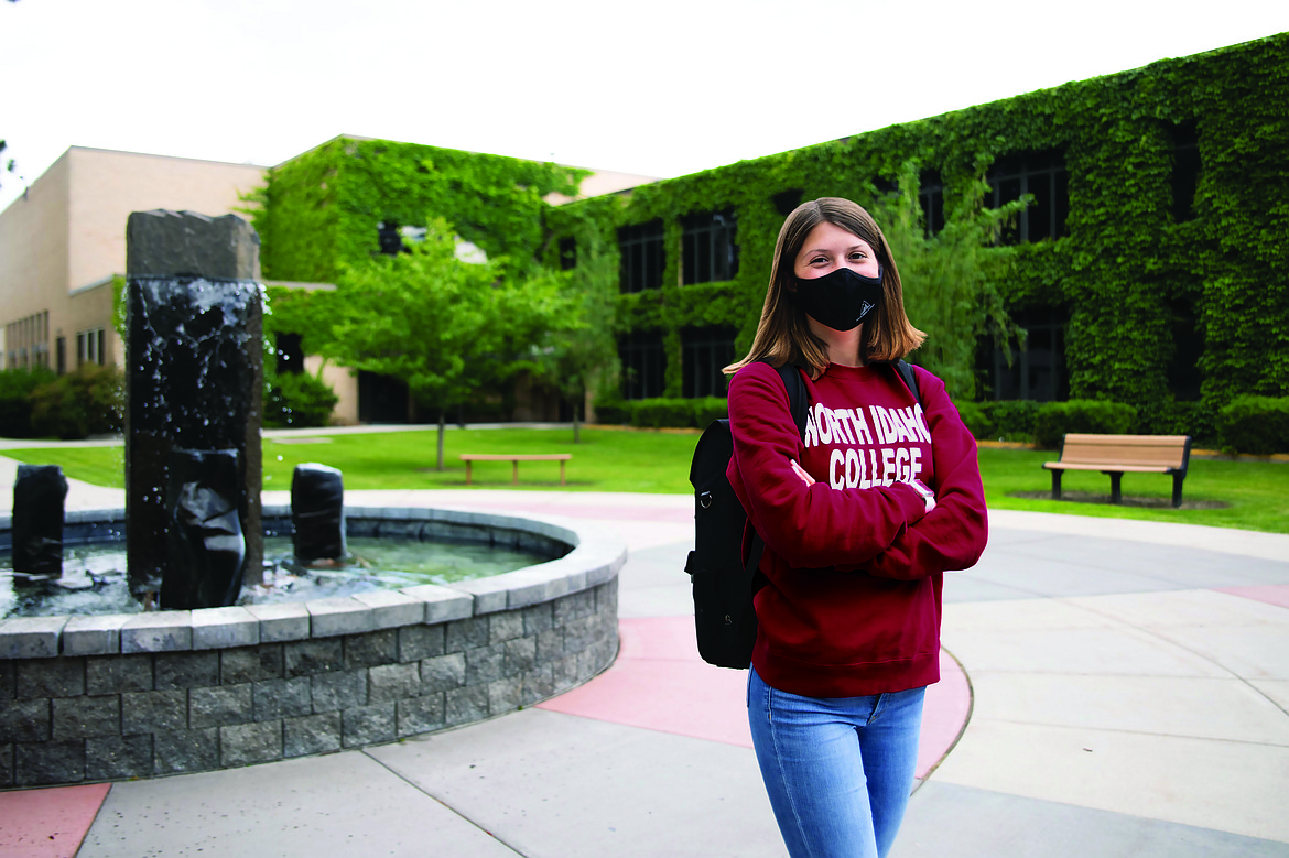 North Idaho College student Jestine Lackner wears her NIC mask to demonstrate how life on campus will look different this fall. NIC is requiring everyone on campus to wear masks while indoors and to physically distance at least six feet to stymie the spread of COVID-19 and protect the health of students and staff alike.