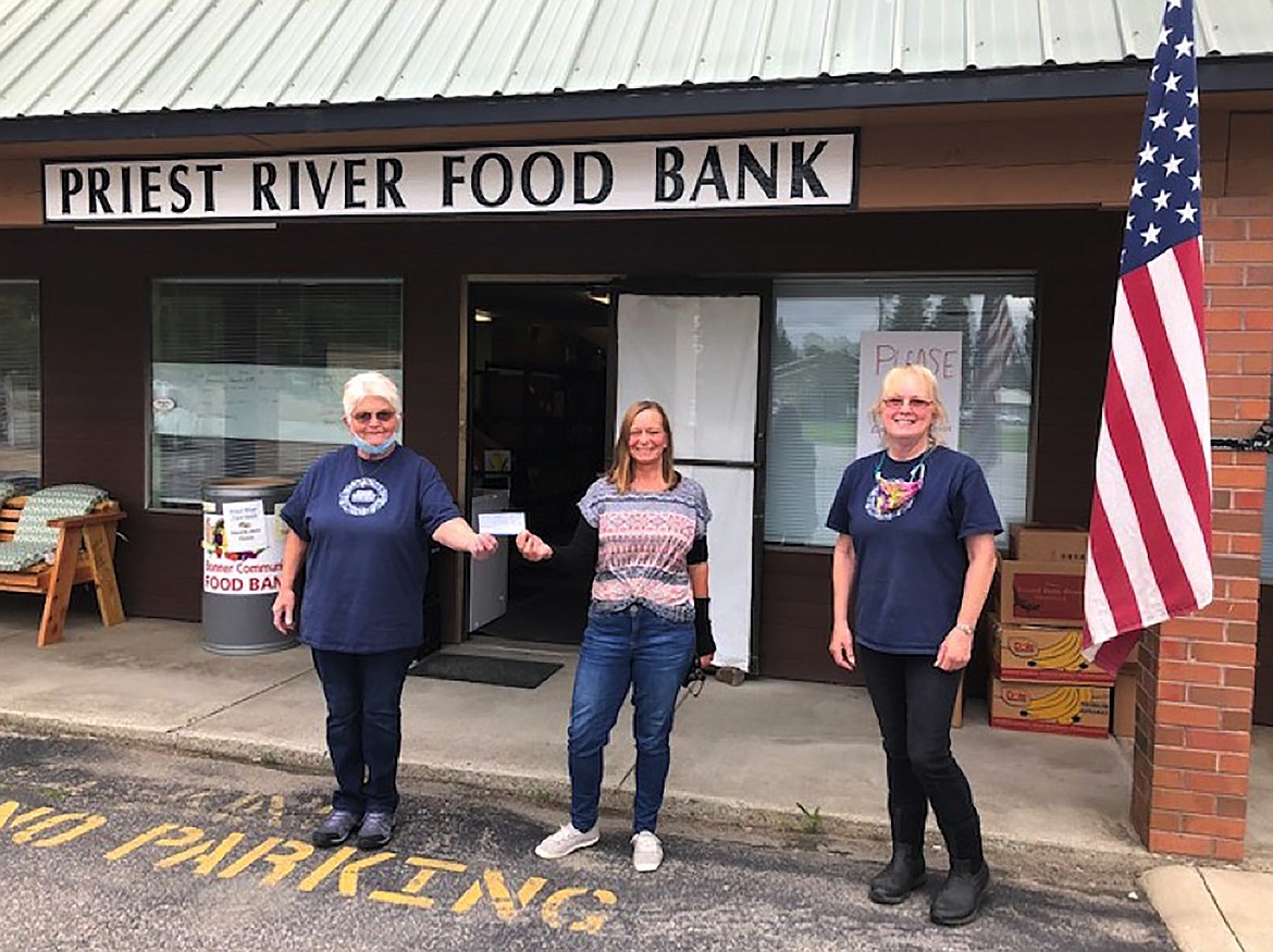 (Courtesy photo) 
 WBCEA President Wilma Hahn poses with food bank volunteers Mary Davis and Kathleen Moore after the association made a surprise donation to the Priest River Food Bank.