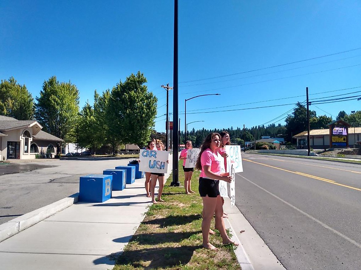 (Courtesy photo) 
 Bonners Ferry High School cheerleaders work to drum up business at a recent car wash.