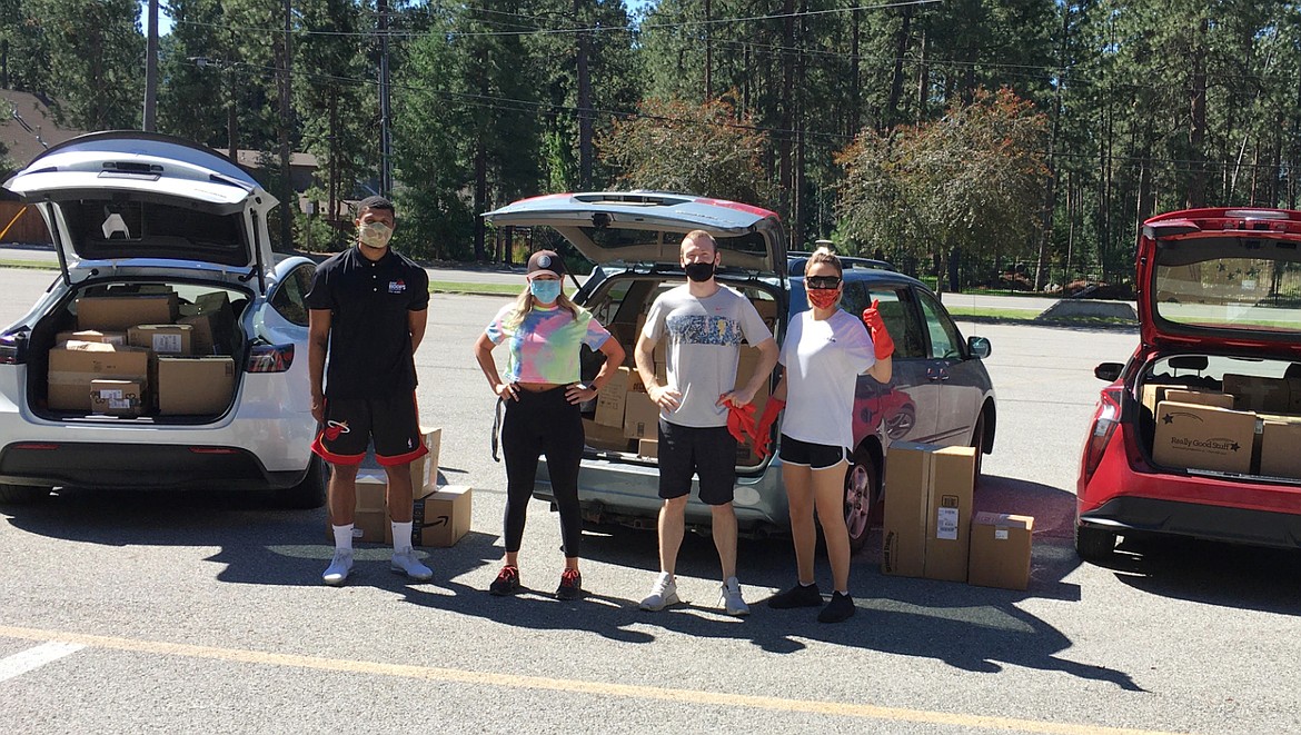 From left, Deon Watson, Danielle Powers, Joel Wasserman and Cami Williams are surrounded by boxes of school supplies as they make a delivery to Ponderosa Elementary in Post Falls in July. Members of the nonprofit Teacher fund donated $7,000 in supplies as a way to show appreciation for the teachers who made a difference in their own academic lives. (Courtesy photo)