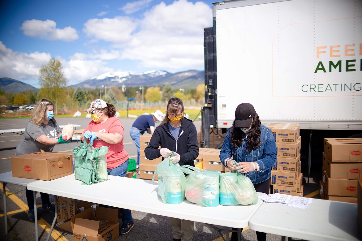 (Photo courtesy CHRIST OUR REDEEMER LUTHERAN CHURCH) 
 Volunteers from Christ Our Redeemer Lutheran Church help out at a recent food distribution event. Christ Our Redeemer Lutheran Church in Sandpoint is partnering with 2nd Harvest of Spokane to bring a fourth emergency food distribution to our area on Friday, Aug. 14.
