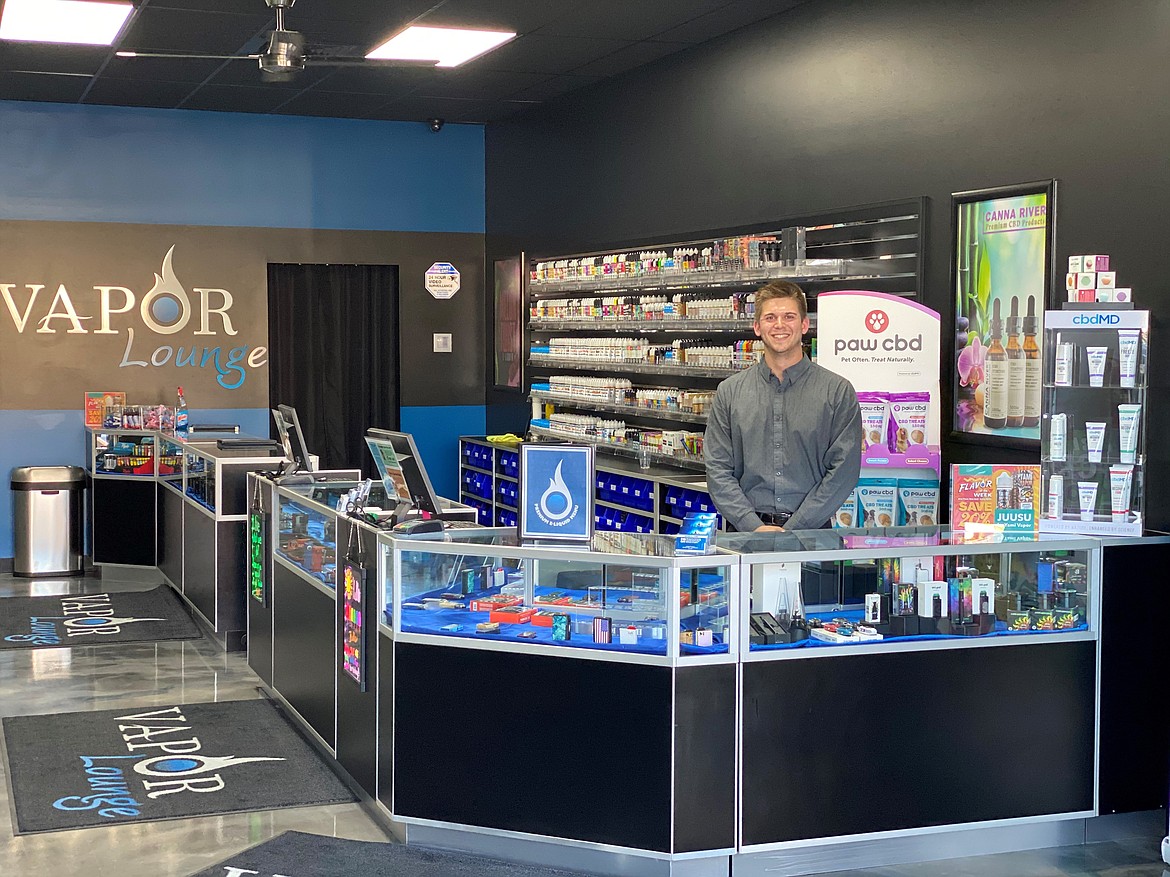 Courtesy photo 
 Vapor Lounge manager Tyler Delgado stands behind the counter of the store's location at 2824 N. Ramsey Road.