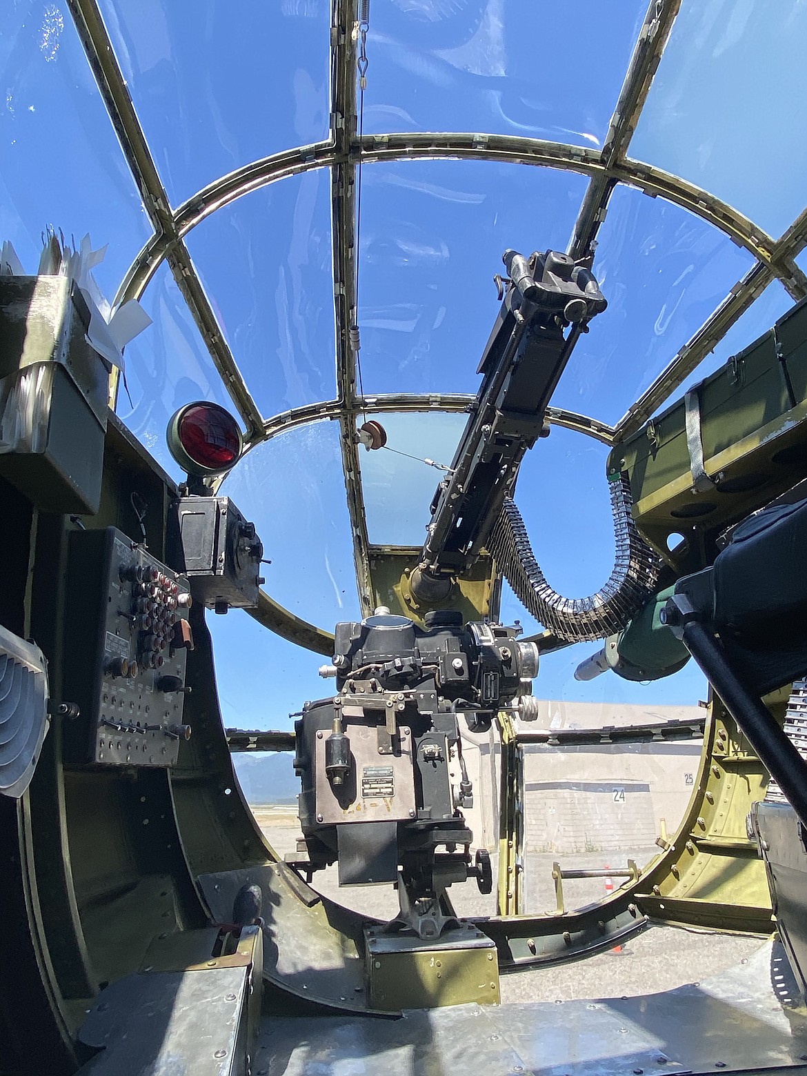 The view out of the World War II B-25J Mitchell warplane the "Maid in the Shade" nose featuring the front gunman position.  (MADISON HARDY/Press)